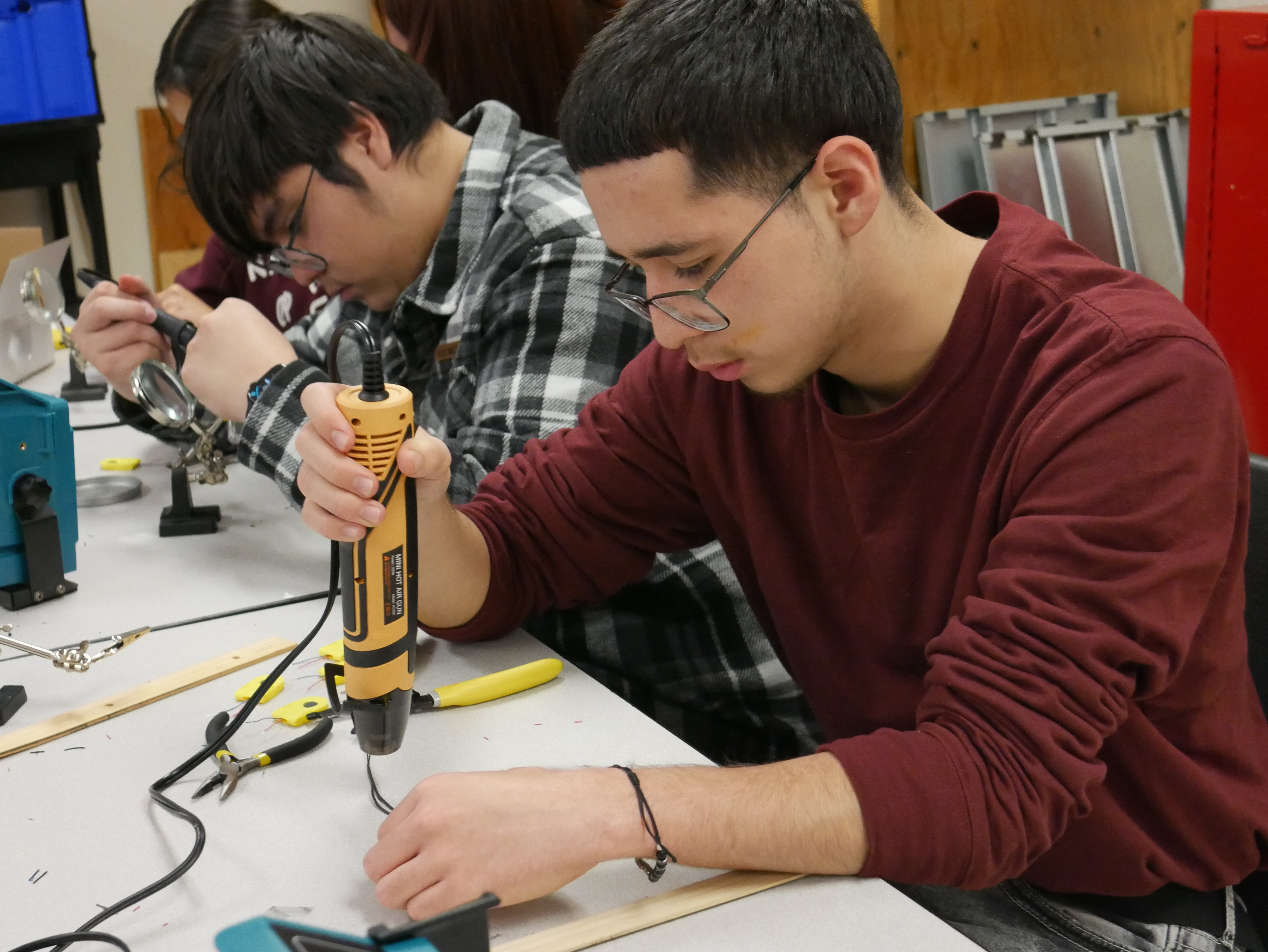 EVHS MESA Students Alexis Hernandez and Julio Aguilar-Vigil work on assembling the gloves